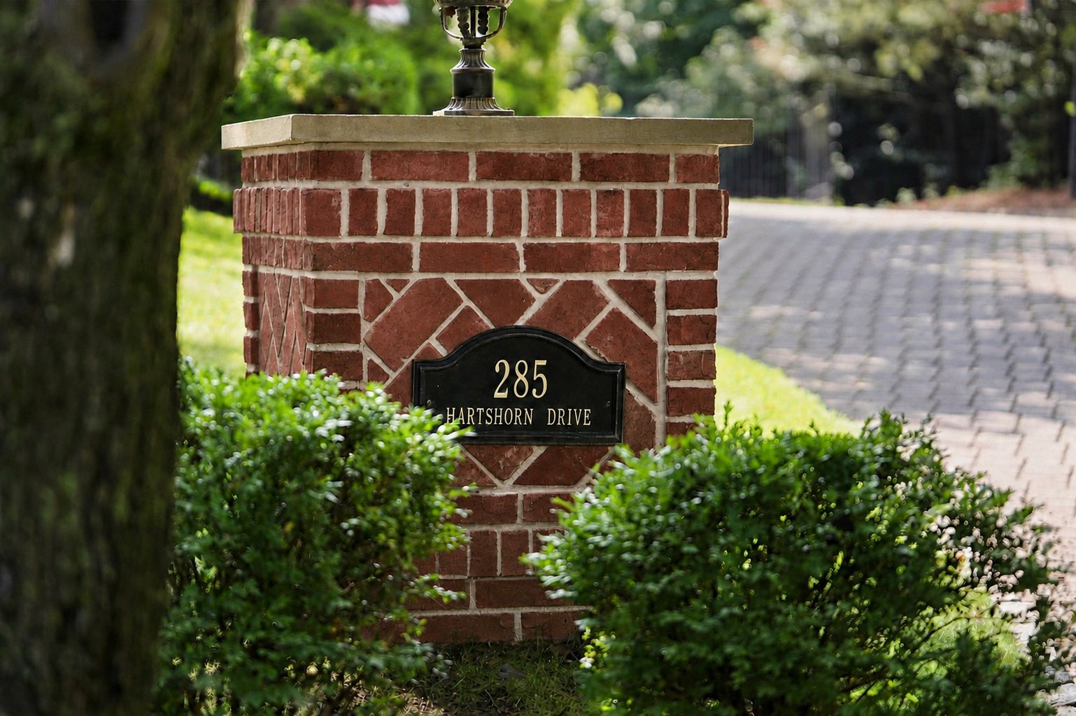 Brick address pillar with 285 Hartshorn Drive nameplate