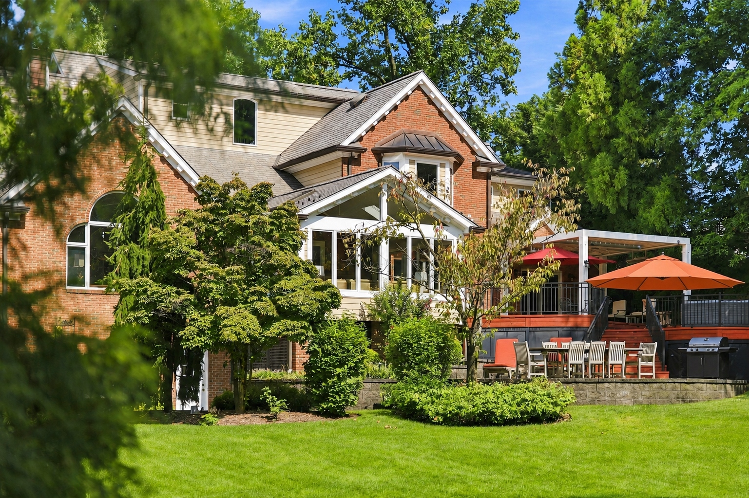rear grounds at 285 Hartshorn Drive with a two-tier patio and expansive lawn