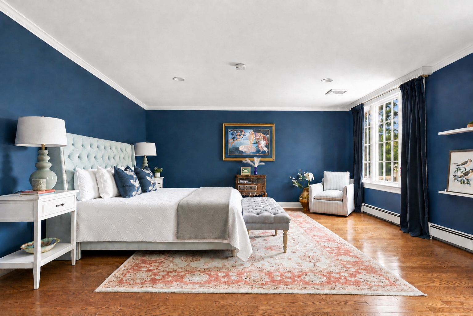 Primary bedroom with tufted upholstered headboard and hardwood flooring at 285 Hartshorn Drive, Short Hills